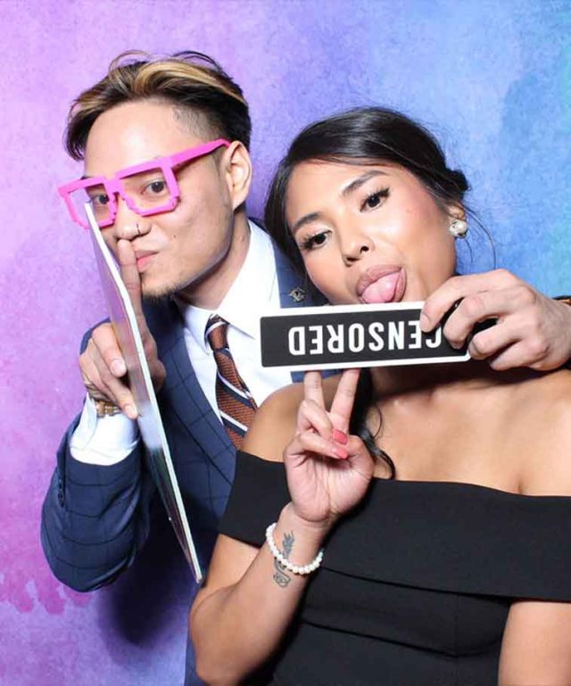 couple holding photo props